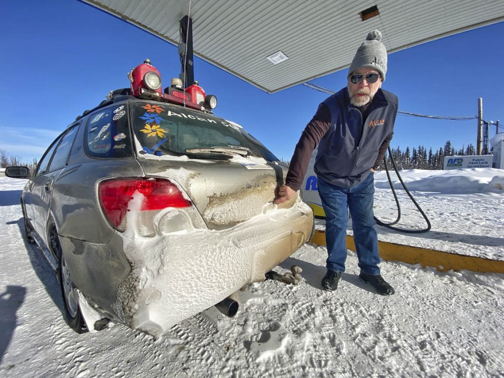 racer fills subaru during alcan 5000 winter rally