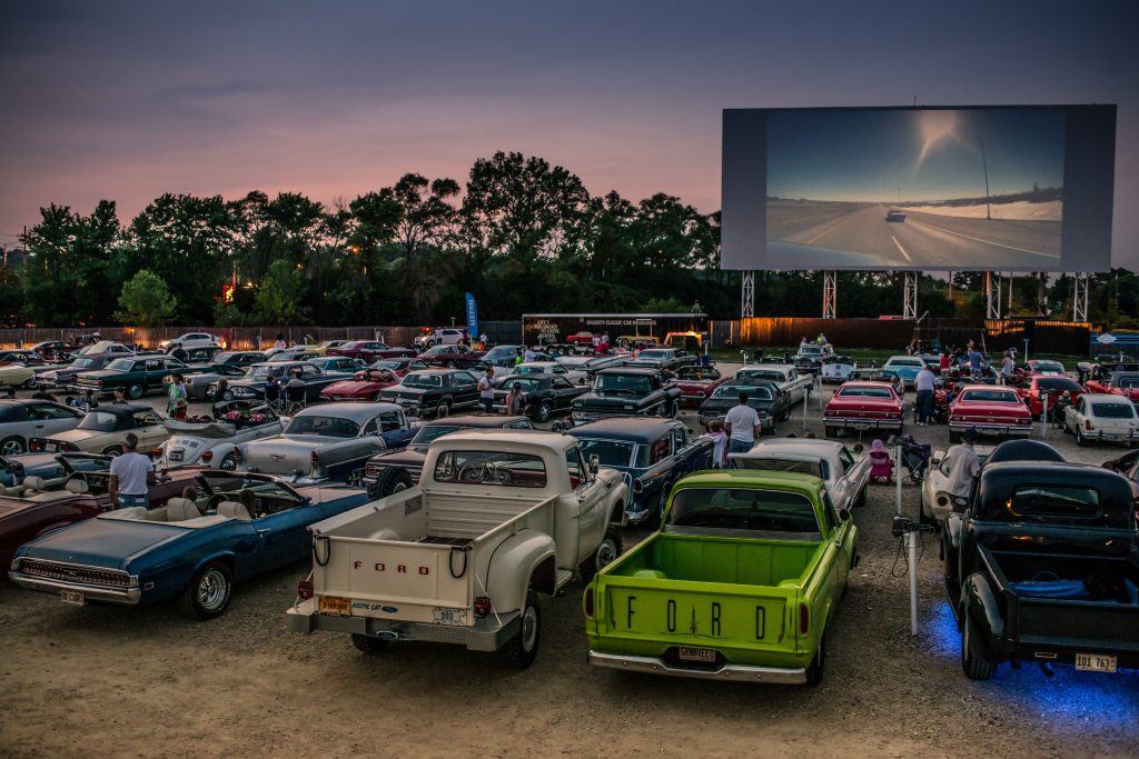 Drive In Theater Lot Filled with Classic Cars at Sunset