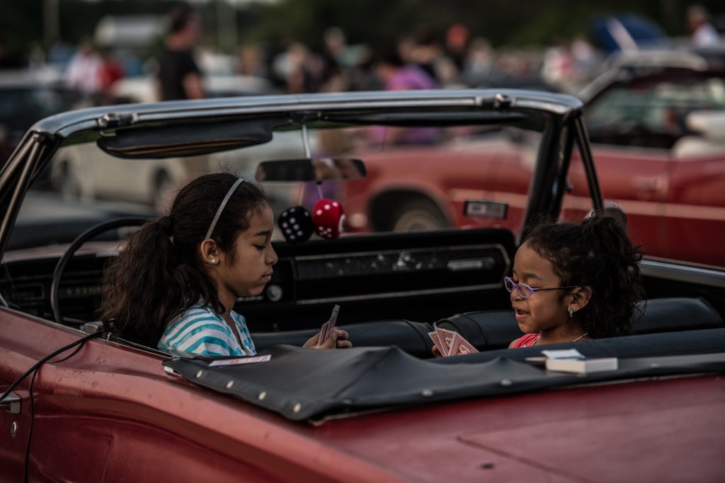 Girls Playing Cards at Drive In Movie Theater